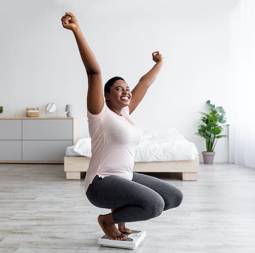 woman celebrating on the scale