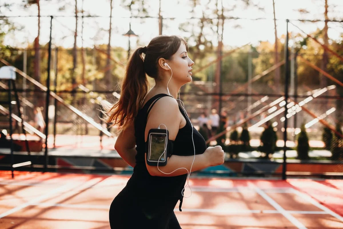 young woman running on a track