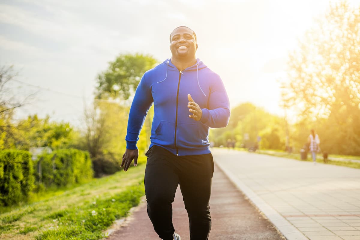 Young sporty man enjoys jogging .