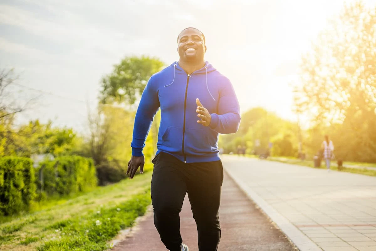 Young sporty man enjoys jogging .