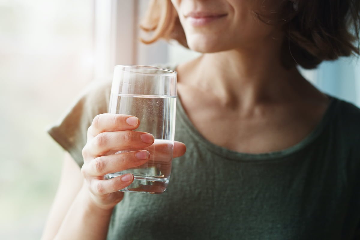 woman drinking a glass of water