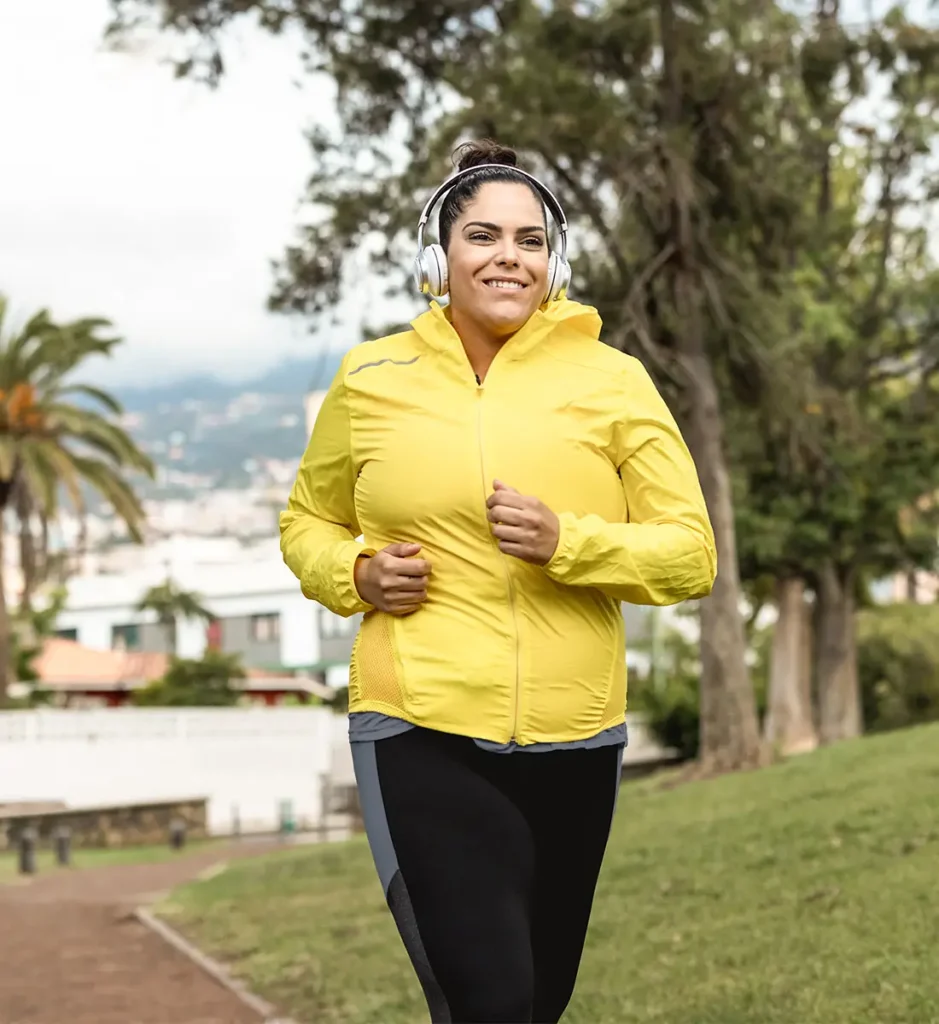 happy plus size woman jogging to lose weight